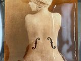 a picture of a woman with a violin on the back of her body