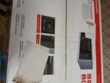 two boxes of electronic equipment sitting on a tiled floor