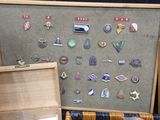 a wooden box with a bunch of pins on it