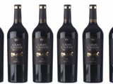 six bottles of red wine are lined up in a row