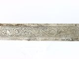 an old silver plate with a decorative design on it