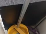a yellow dust pan sitting on the floor next to a toilet