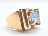 an image of a gold ring with a blue stone in the center