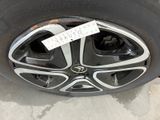 the rim of a car with a sticker on it ' s tire