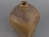 a brown vase that is sitting on a table