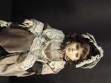 a doll that is standing on a black surface
