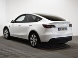 the tesla model x is parked in a white room