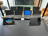 four laptops sitting on a table in a room