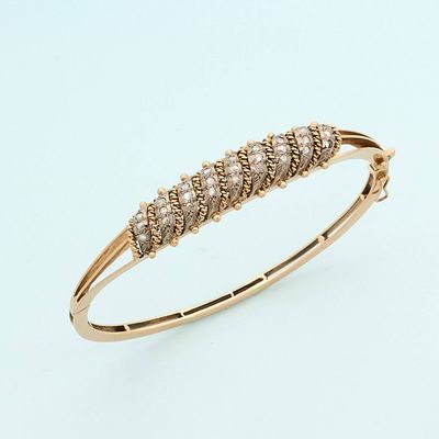 a close up of a gold bracelet with five diamonds on it