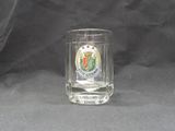 a shot of a glass with a crest on it