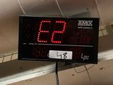a digital clock on the ceiling of a building