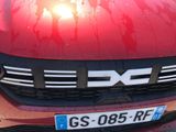 a close up of a red car with a dirty hood