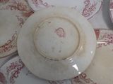 a white plate with red designs on it on a table