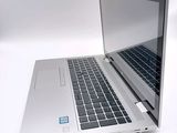 a laptop that is open on a white surface