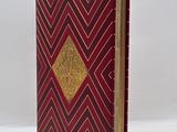 a red and gold book with a gold diamond on the cover