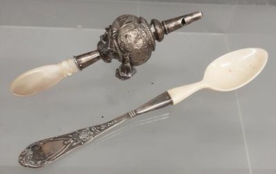 two spoons and a spoon rest on a glass table