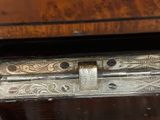 a close up of a metal latch on a wooden cabinet
