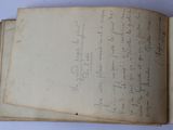 an open book with writing on it sitting on top of a table