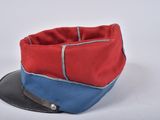 a red and blue hat sitting on top of a black hat