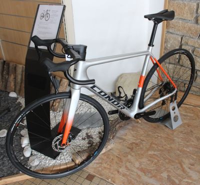 a bike that is sitting on the floor in front of a wall