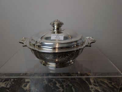 a silver plate with a glass lid on a table