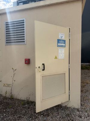 a door that has a sign on it in front of a building