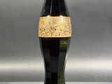 a black vase with a gold stripe on it