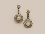 a pair of pearl and diamond earrings