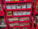 a red shelving with lots of boxes on top of it