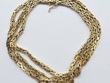 a gold chain bracelet with a clasp on a white background