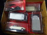 a box with four different model cars inside of it