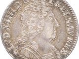 a silver coin with a woman ' s head on it