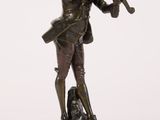 an antique bronze statue of a man playing a violin on a wooden base