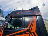 a truck with an orange and black design on the side of it
