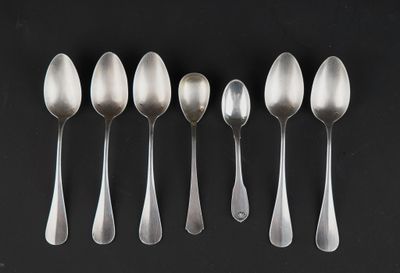 six silver spoons are lined up in a row on a black surface