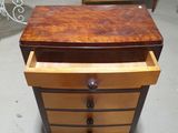 an image of a dresser with drawers and a table in the background