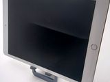 a tablet computer sitting on a stand on a table