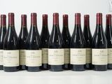 six bouteilles de vin sont alignées sur une table