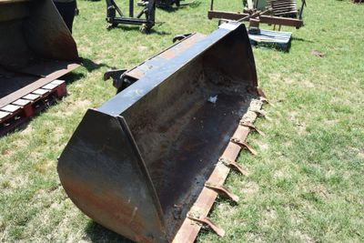 a bulldozer that is sitting in the grass