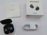 a box of earphones sitting on a table next to a pair of batteries