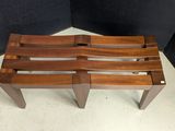 an image of a wooden bench sitting in a corner of a room
