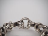 a close up of a chain bracelet with a clasp