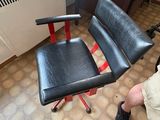a man that is sitting on a chair in a room