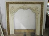 a marble fireplace surround in a room with a tile floor