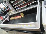 a display case with a sandwich on it in a store