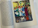 an open book with a picture of a group of people and a dog