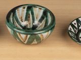 three vases sitting on a table next to each other