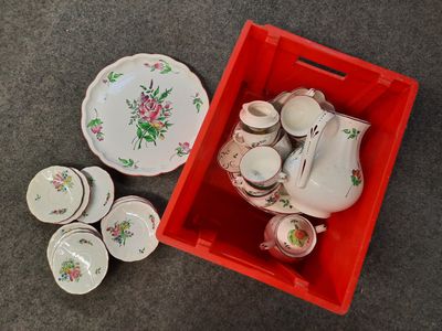 a red box with a bunch of plates and cups in it