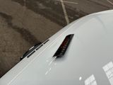 a remote control on the hood of a white car