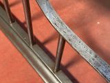 a close up of a metal railing on a red floor
